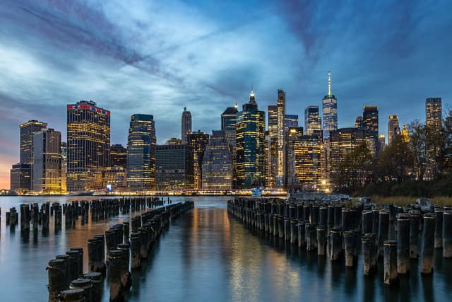 The Lower Manhattan skyline at dusk, seen from Brooklyn across the East River